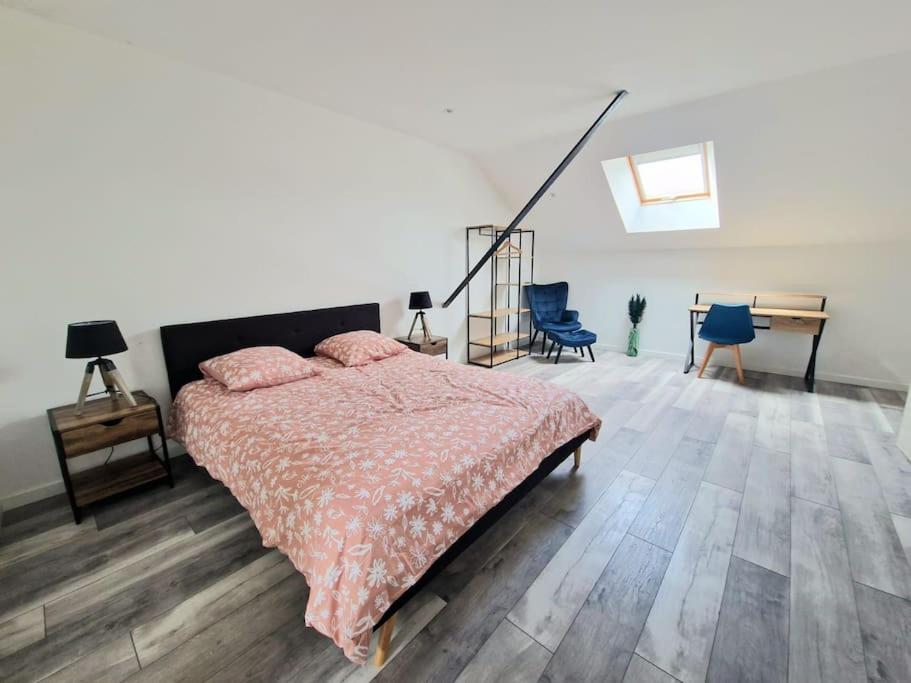 a bedroom with a bed and a table and chairs at Maison 3 chambres avec jardin in Bouxières-aux-Dames