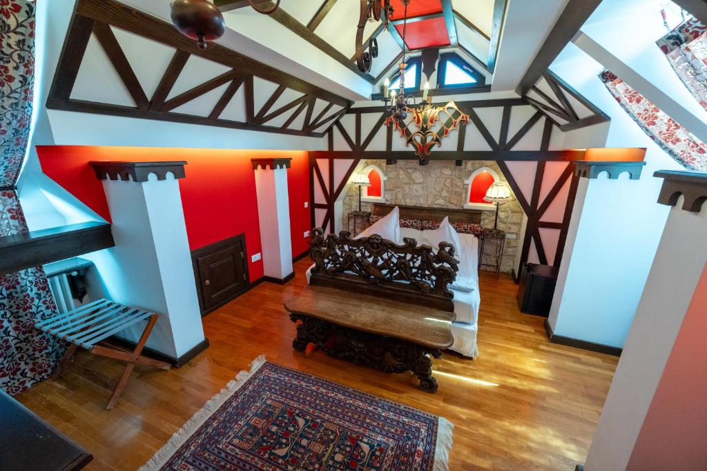 a living room with a bed and a fireplace at Casa Din Bran - Inn Center in Bran