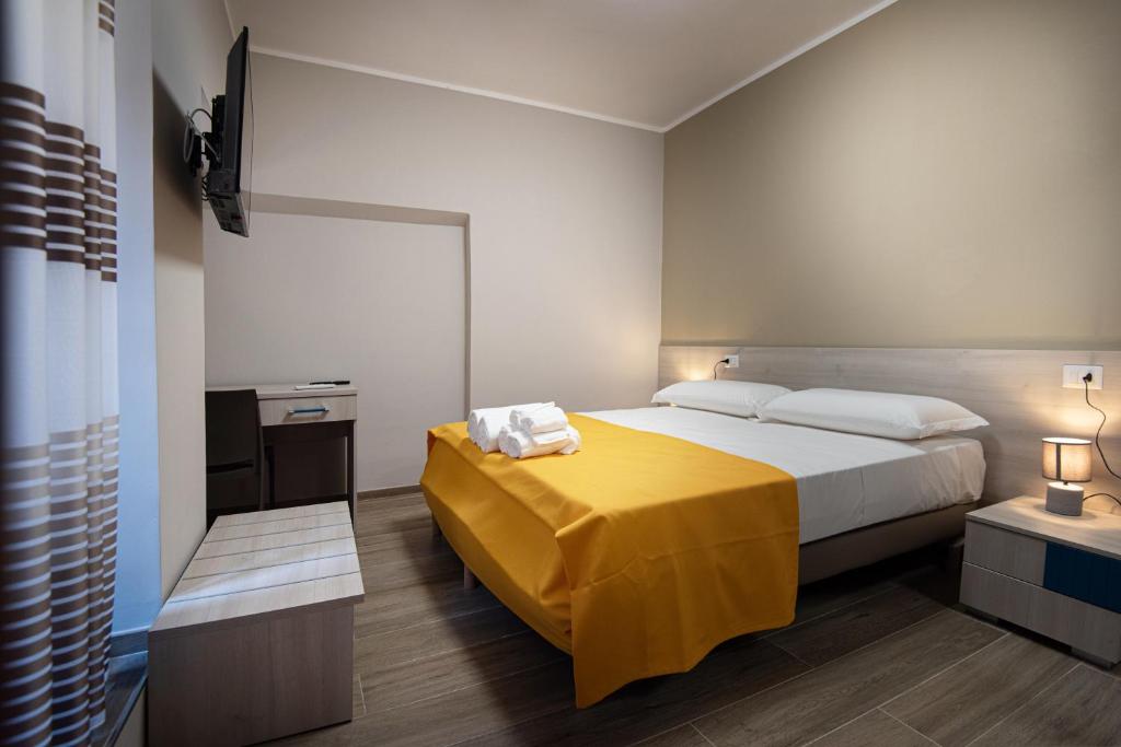 Postel nebo postele na pokoji v ubytování Nella mia città