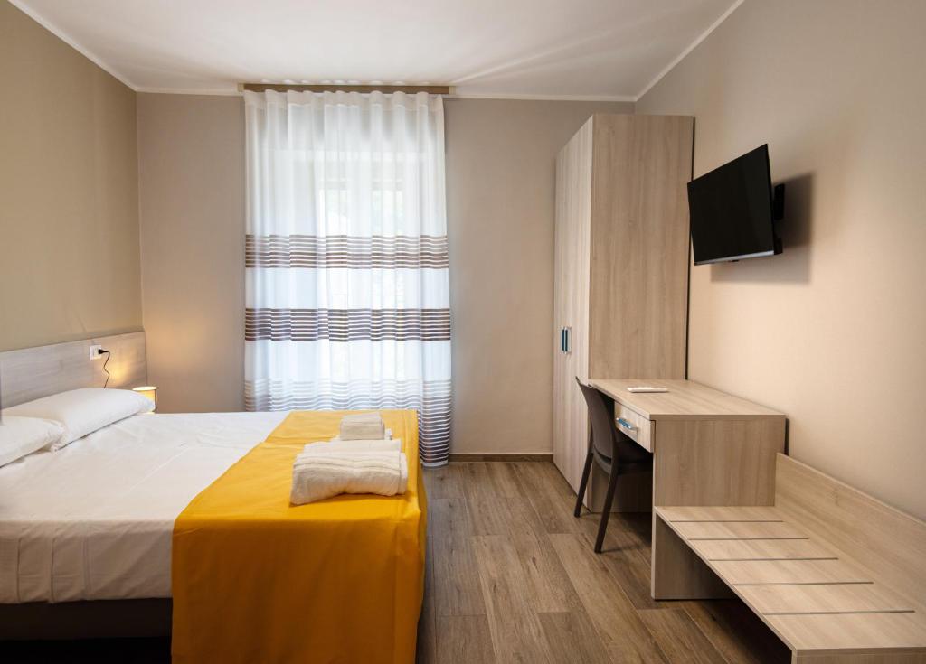 Postel nebo postele na pokoji v ubytování Nella mia città