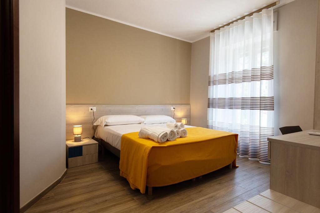 Postel nebo postele na pokoji v ubytování Nella mia città