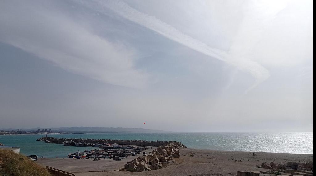 a beach with a group of boats in the water at Maison de vacances vue sur la mer in Mazer