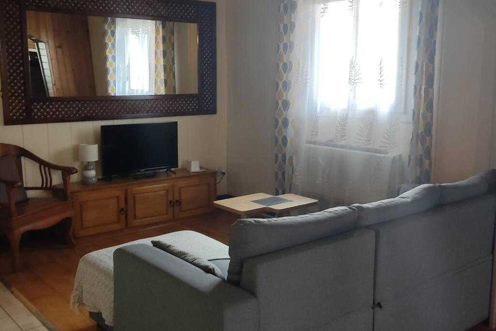 a living room with a couch and a television at Chez Ti Roland et Josie in Le Tampon