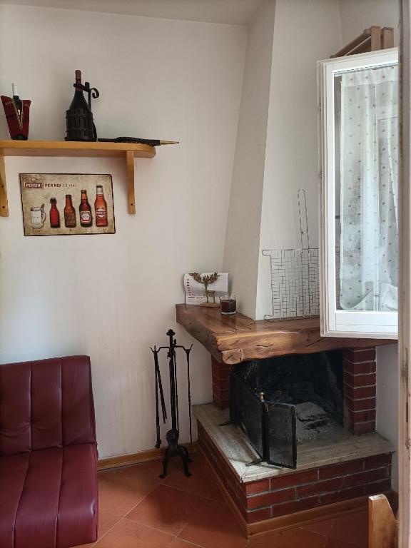 a living room with a fireplace and a couch at Chalet Erminia in Castel di Sangro