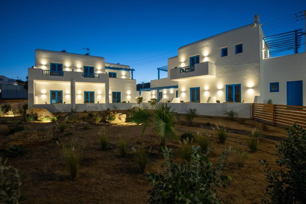 a large white house with lights on it at night at Corfos Pearl Studios in Ornos