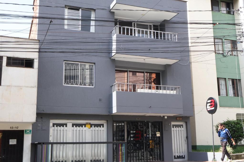 a man walking in front of a building at Living Poblado Manila 301 C Habitación Individual in Medellín