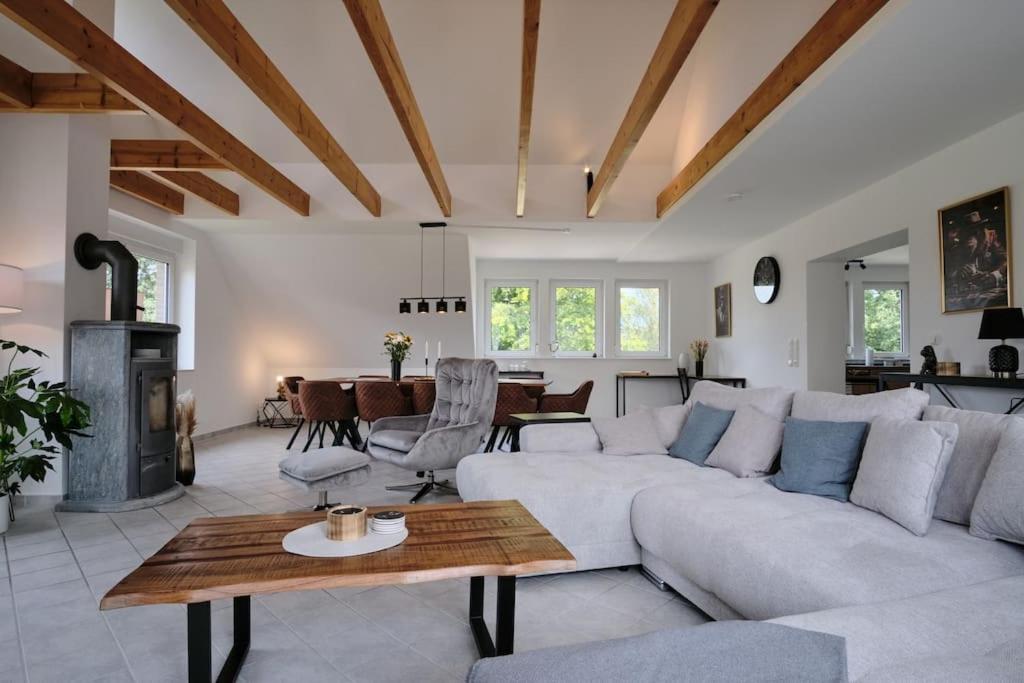 a living room with a white couch and a table at Ferienwohnung 12 Monkeys in Stuhr