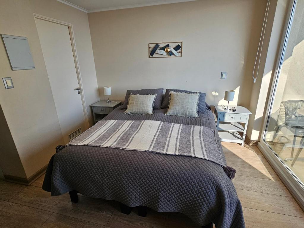 a bedroom with a large bed in a room at Departamento Centro Osorno in Osorno