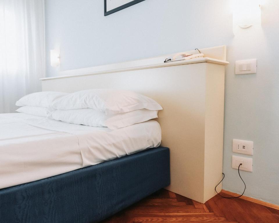 Postel nebo postele na pokoji v ubytování Hotel all'Oasi