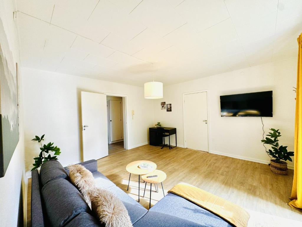 a living room with a couch and a table at aday - Solsortvej Suite 2 Randers in Randers