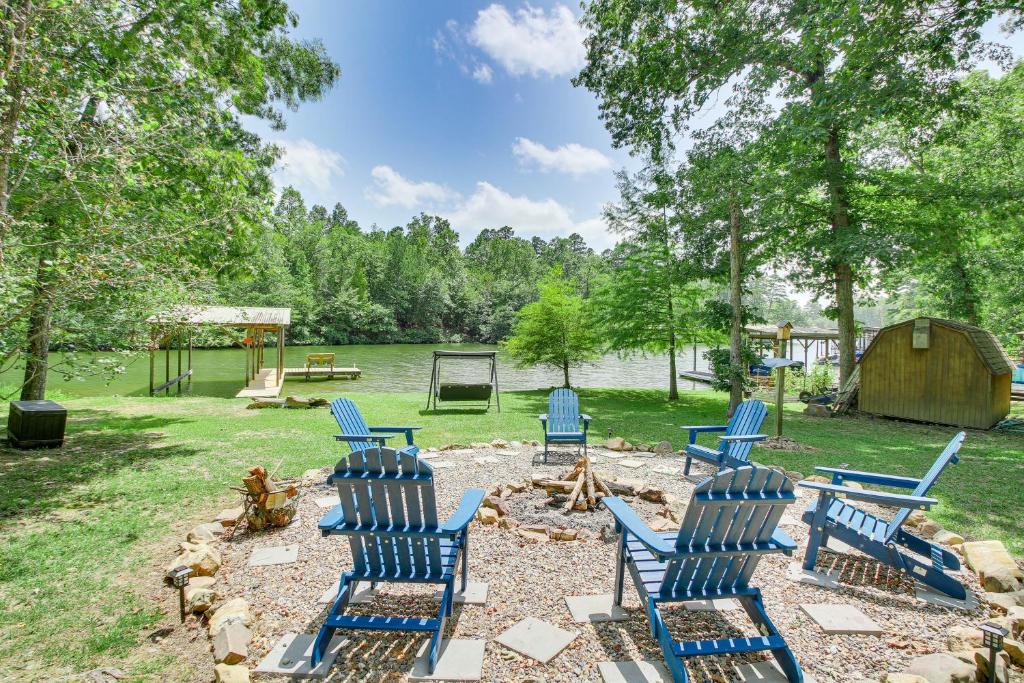 a group of blue chairs sitting in a yard at Hot Springs Retreat with Private Dock and Hot Tub! in Hot Springs