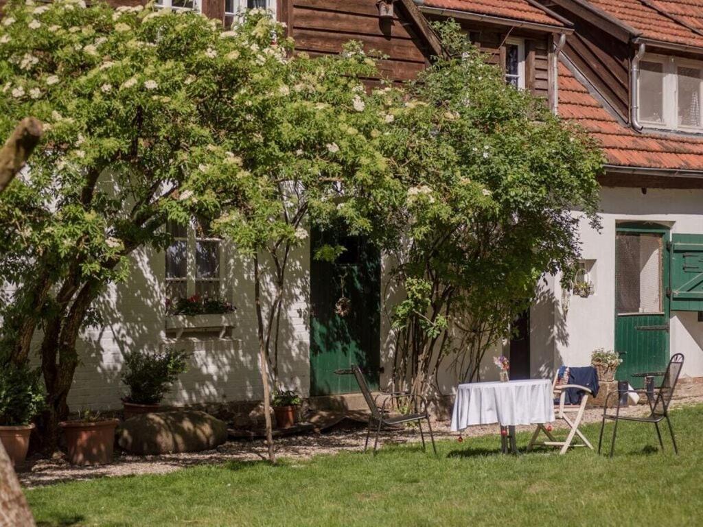 a table and chairs in front of a house at Holiday apartment Kutscherstube in Altenbeken