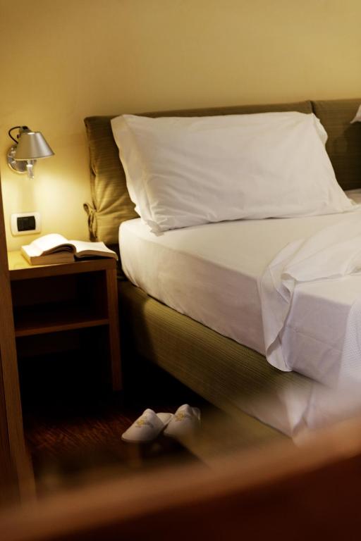 Postel nebo postele na pokoji v ubytování Hotel Palazzo Papaleo
