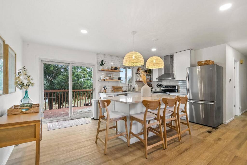 a kitchen with a white table and a refrigerator at Downtown Monument, Family Friendly, Remodel in Monument