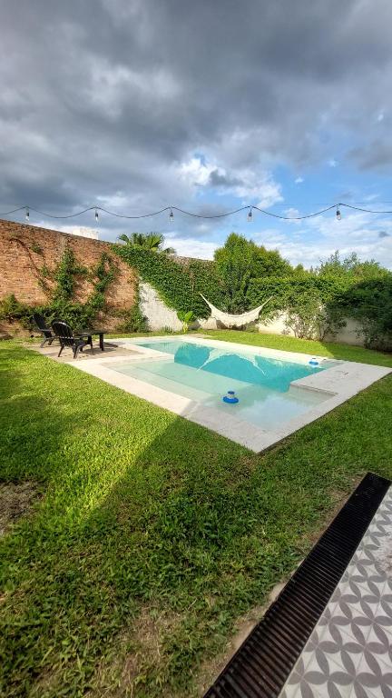 a swimming pool in the middle of a grass field at La beethoven YB in Yerba Buena