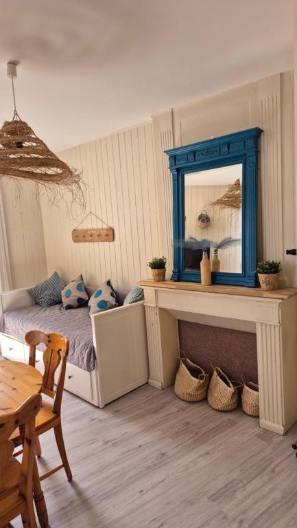 une chambre avec un lit, un miroir et une table dans l'établissement L'endroit idéal au croisic, au Croisic