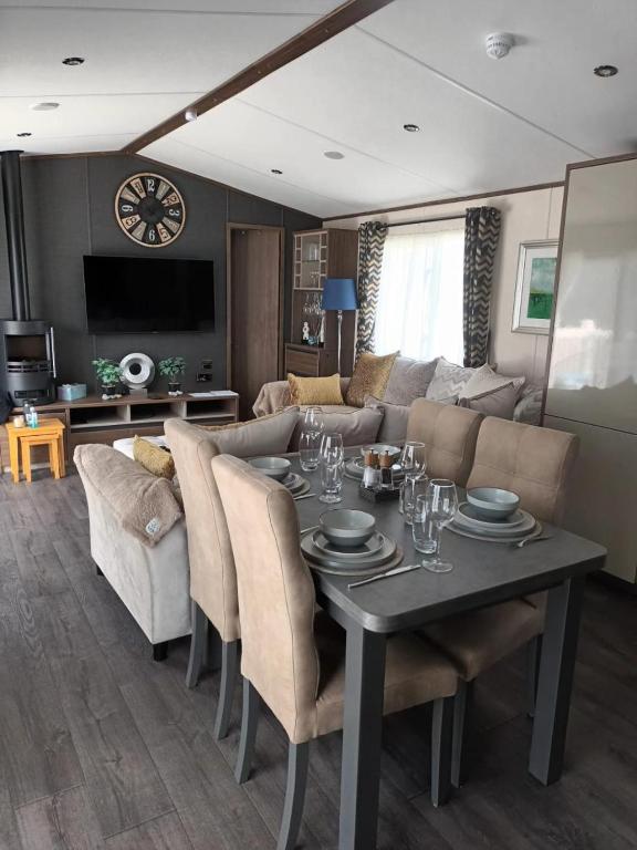 a living room with a table and a couch at Beechwood 20 in Camber