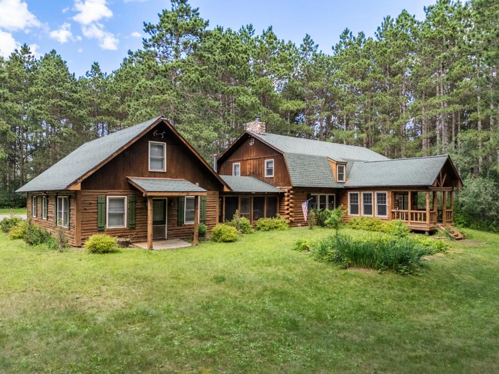 a log home with a large yard at 8BR 5BA Huge Dog Friendly Log Cabin near Wisconsin Dells and Lake sleeps 25plus in Mauston