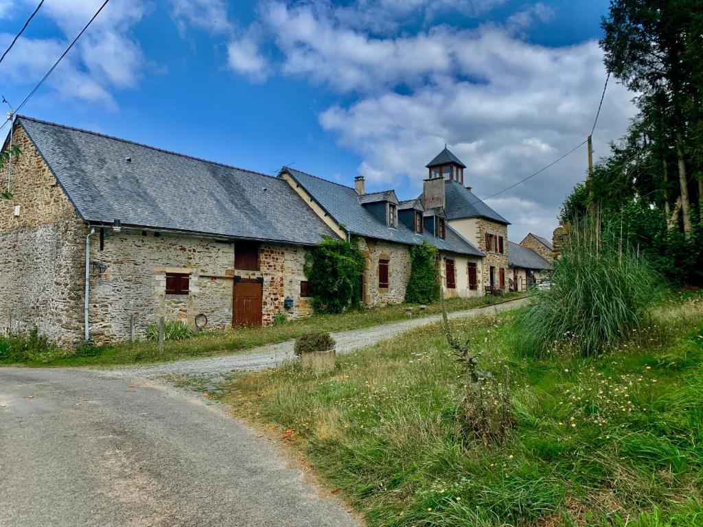 an old stone building on the side of a road at La Meltiere Sleeps 4 with Garden in Courcité