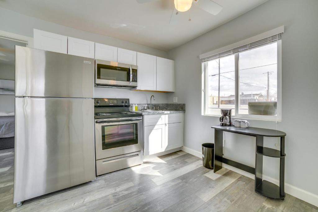 a kitchen with stainless steel appliances and a table at Renovated Hawthorne Apartment By Museums and Dining! in Hawthorne