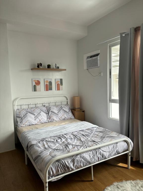 Ένα ή περισσότερα κρεβάτια σε δωμάτιο στο Mesatierra Garden Residences By Prime Staycation Davao