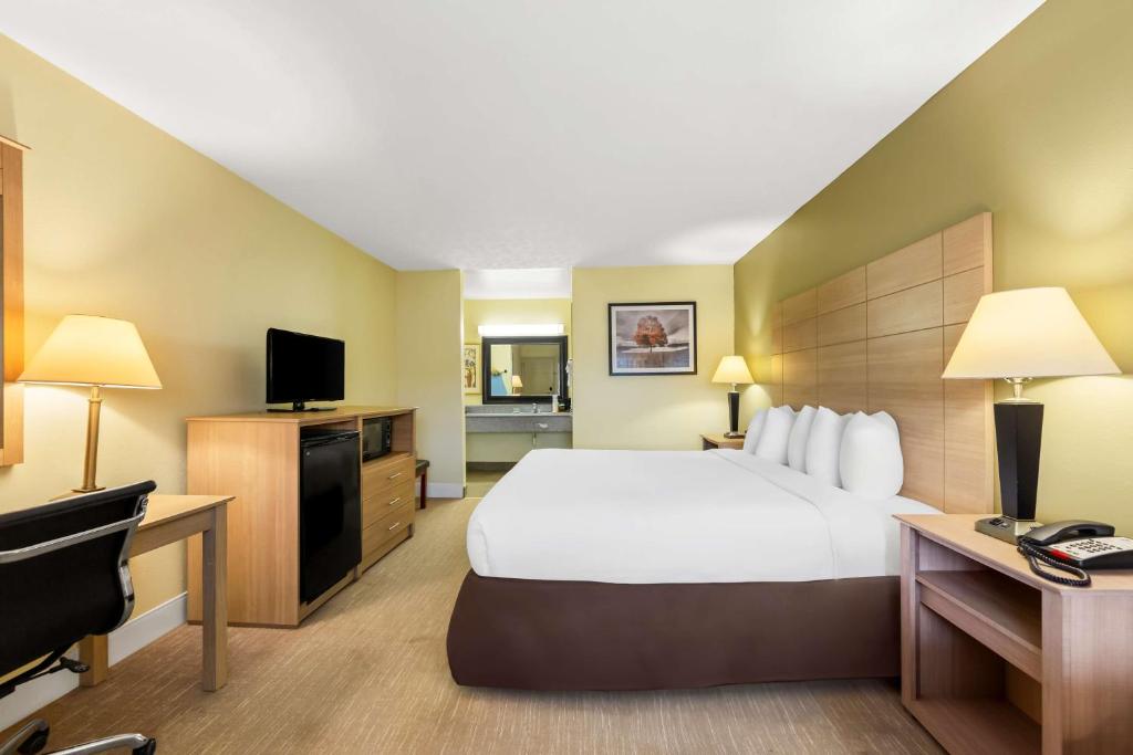 a hotel room with a bed and a desk at Best Western Dayton in Dayton