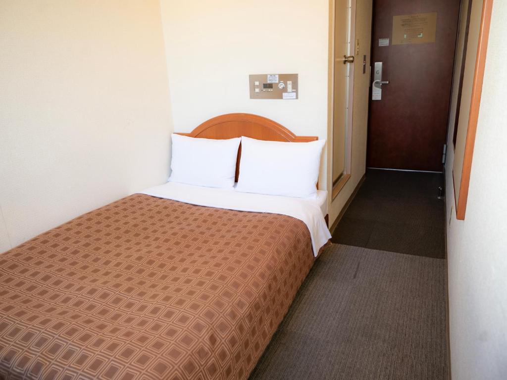 Postel nebo postele na pokoji v ubytování Numazu Grand Hotel