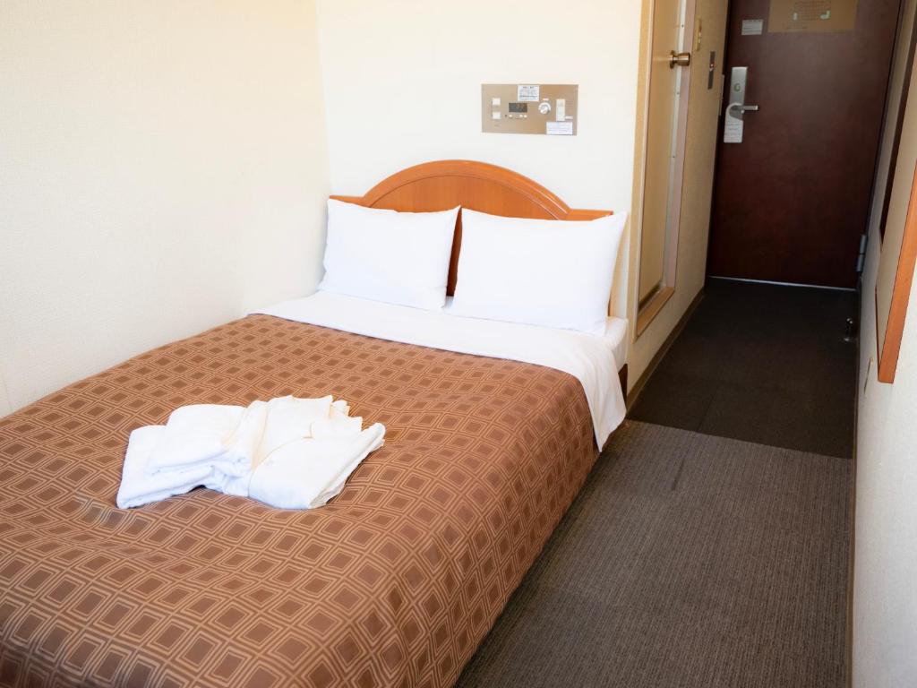 Postel nebo postele na pokoji v ubytování Numazu Grand Hotel