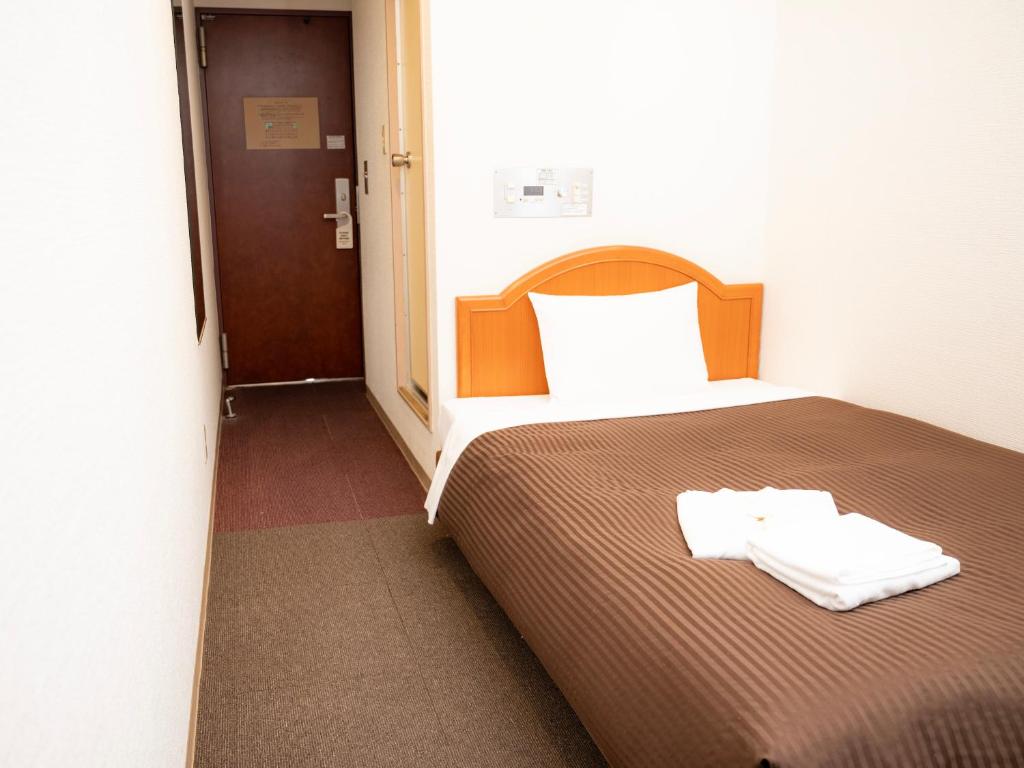Postel nebo postele na pokoji v ubytování Numazu Grand Hotel