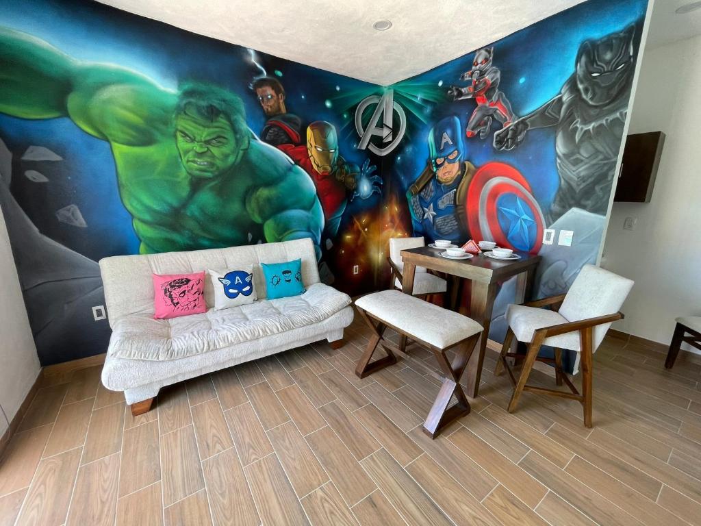 a living room with a superhero mural on the wall at advengers Bucerias Nayarti in Bucerías