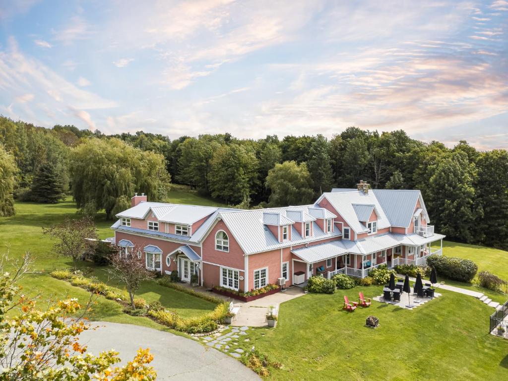 an aerial view of a large pink house at Auberge Le Tricorne in North Hatley