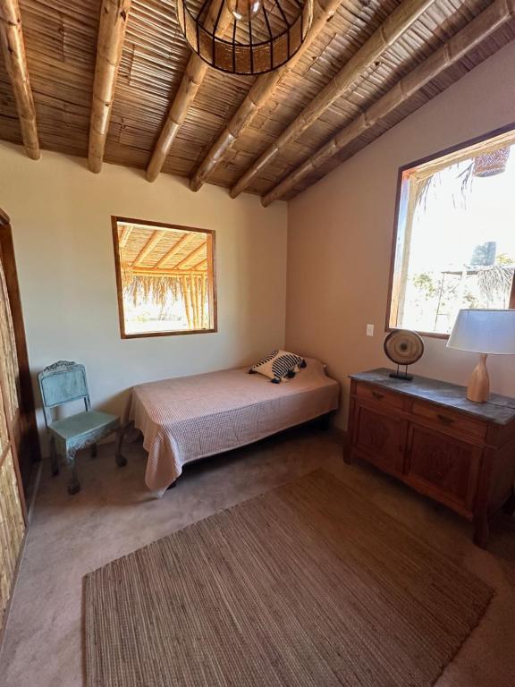 a bedroom with a bed and a desk and a window at ALDEA DEL MAR by Villa del Sol in Máncora
