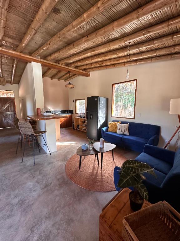 a living room with a blue couch and a table at ALDEA DEL MAR by Villa del Sol in Máncora