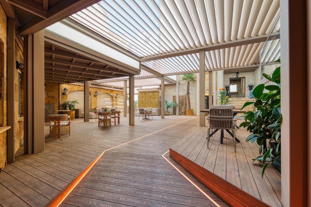 an indoor patio with awning and tables and chairs at Caballero Errante in Madrid