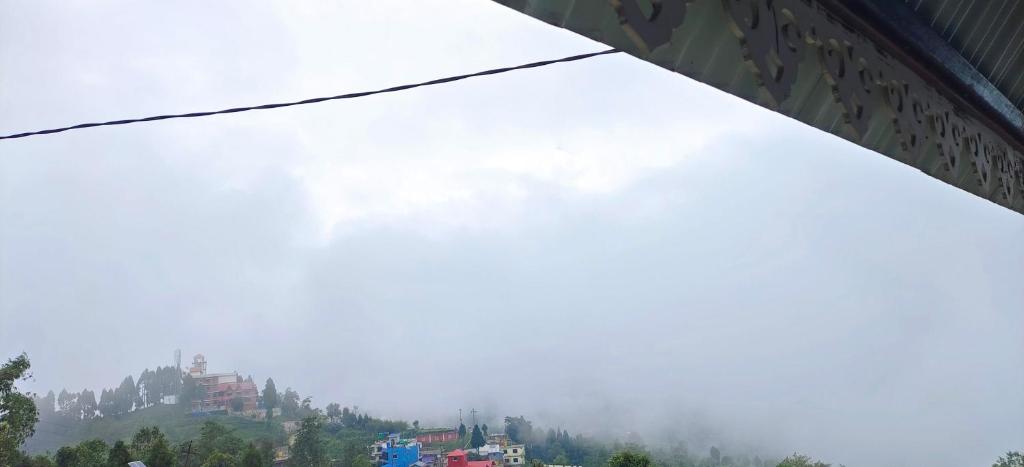 a view of a mountain with clouds in the sky at Zero Points TheLaure Cottage in Ilām