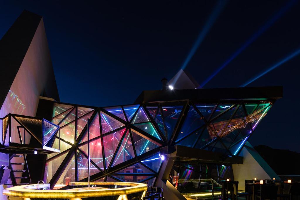 a building with a lit up facade at night at Boton Blue Hotel & Spa in Nha Trang