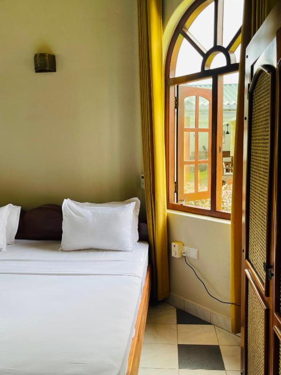 Postel nebo postele na pokoji v ubytování Crystal Villa Weligama