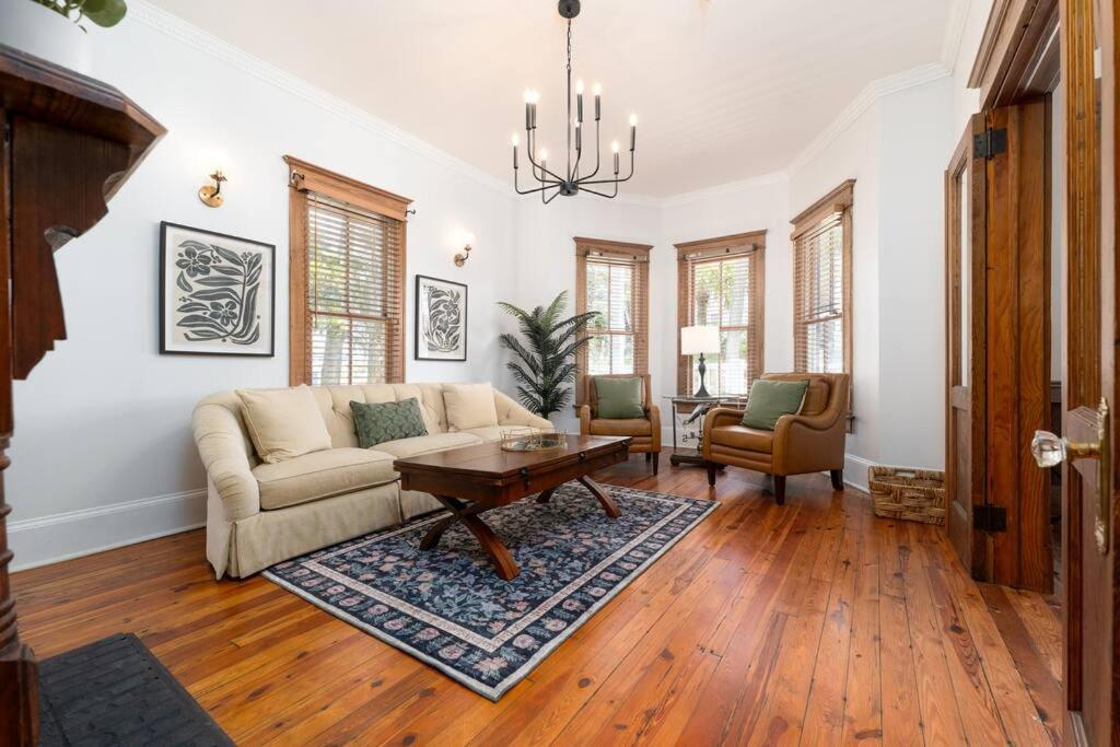 a living room with a couch and a table at Be A Nomad - Combined Pool Home 1 blck to Beach in Jacksonville Beach