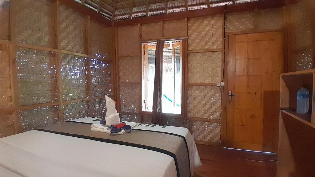 Postel nebo postele na pokoji v ubytování Bayan Exotic Homestay