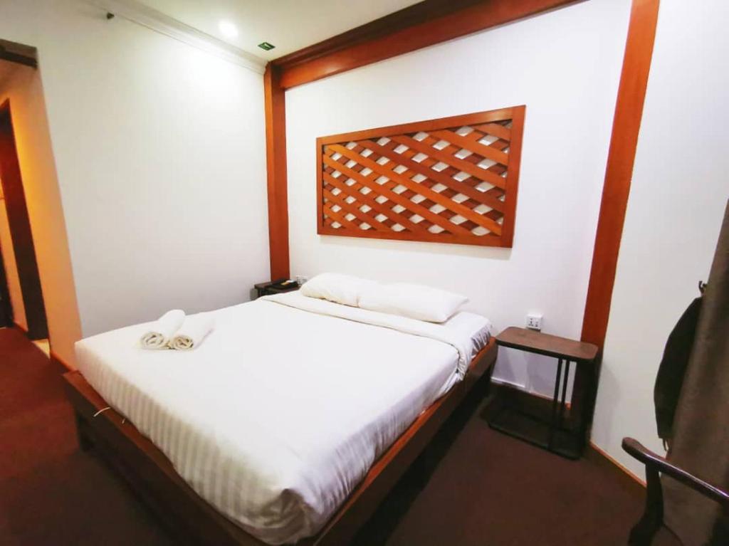 Postel nebo postele na pokoji v ubytování Regalodge Hotel & Spa Ipoh