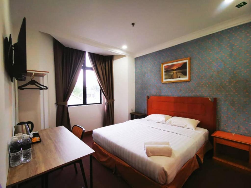 Postel nebo postele na pokoji v ubytování Regalodge Hotel & Spa Ipoh