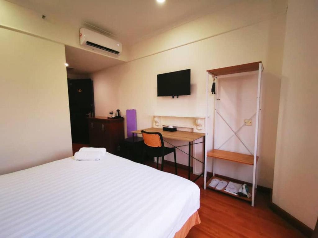 Postel nebo postele na pokoji v ubytování Regalodge Hotel & Spa Ipoh