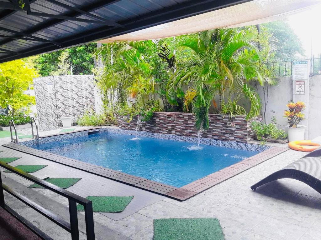 a swimming pool in the middle of a yard at SimoyNorte Private Resort Beneg, Botolan, Zambales, Philippines in Zambales