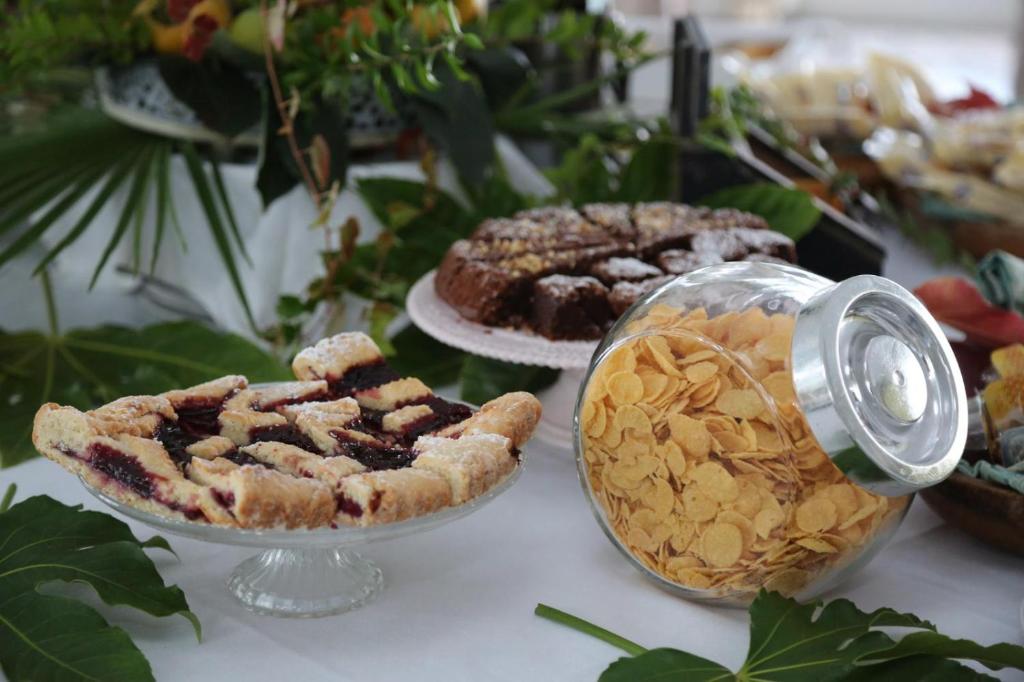 a table with pies and other desserts on it at Hotel Villa Lubrense Sorrento in Massa Lubrense