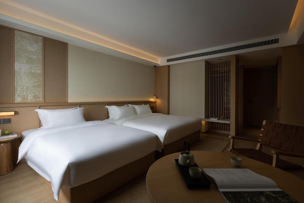 Postel nebo postele na pokoji v ubytování Yanyu Yunxi Resort Hotel 烟雨云兮酒店