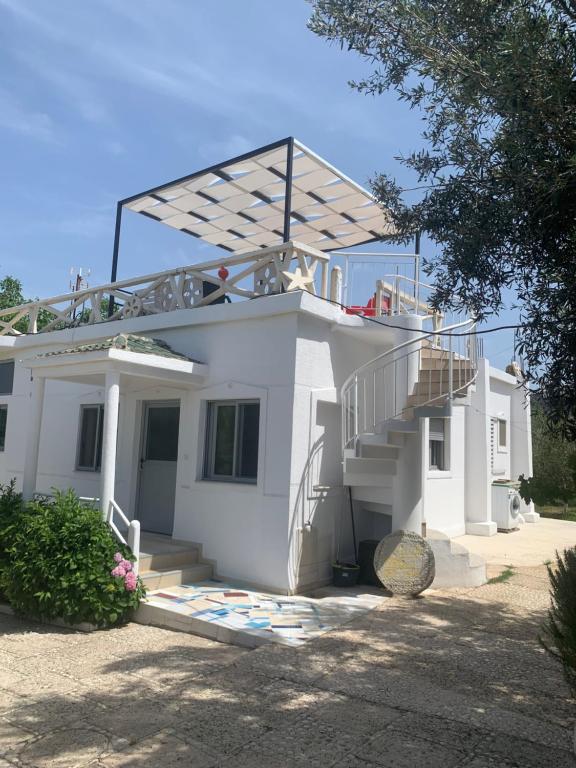 a white house with stairs and a roof at Villas Ermali in Ksamil