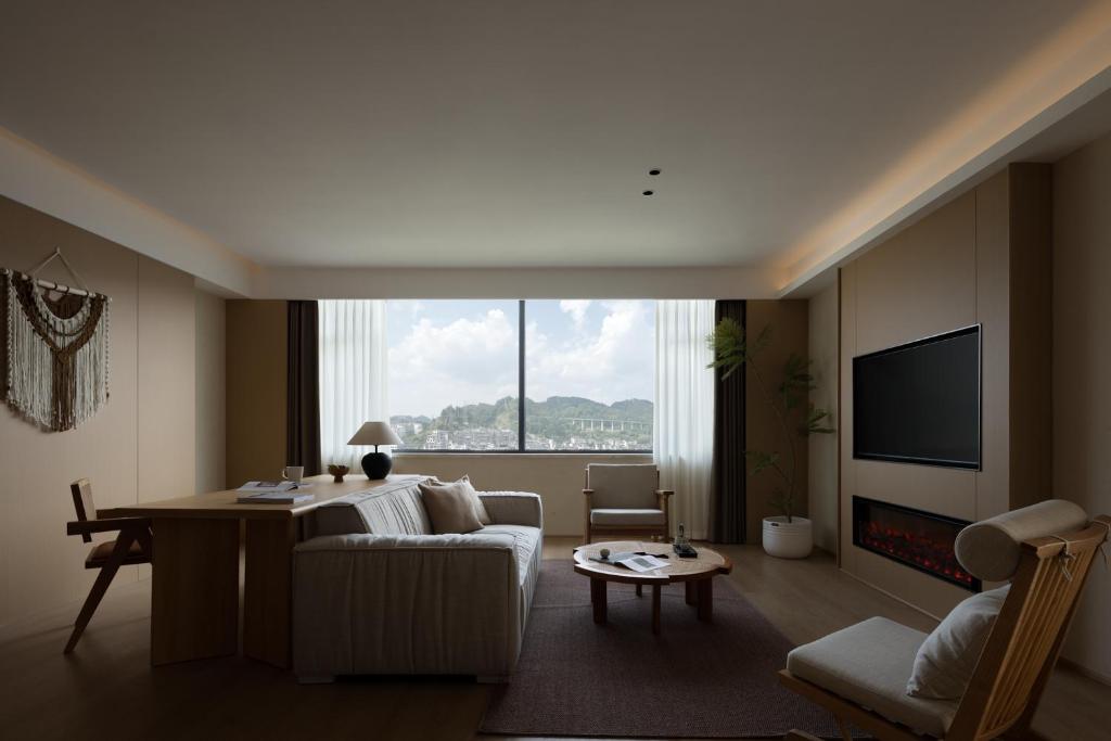 TV a/nebo společenská místnost v ubytování Yanyu Yunxi Resort Hotel 烟雨云兮酒店