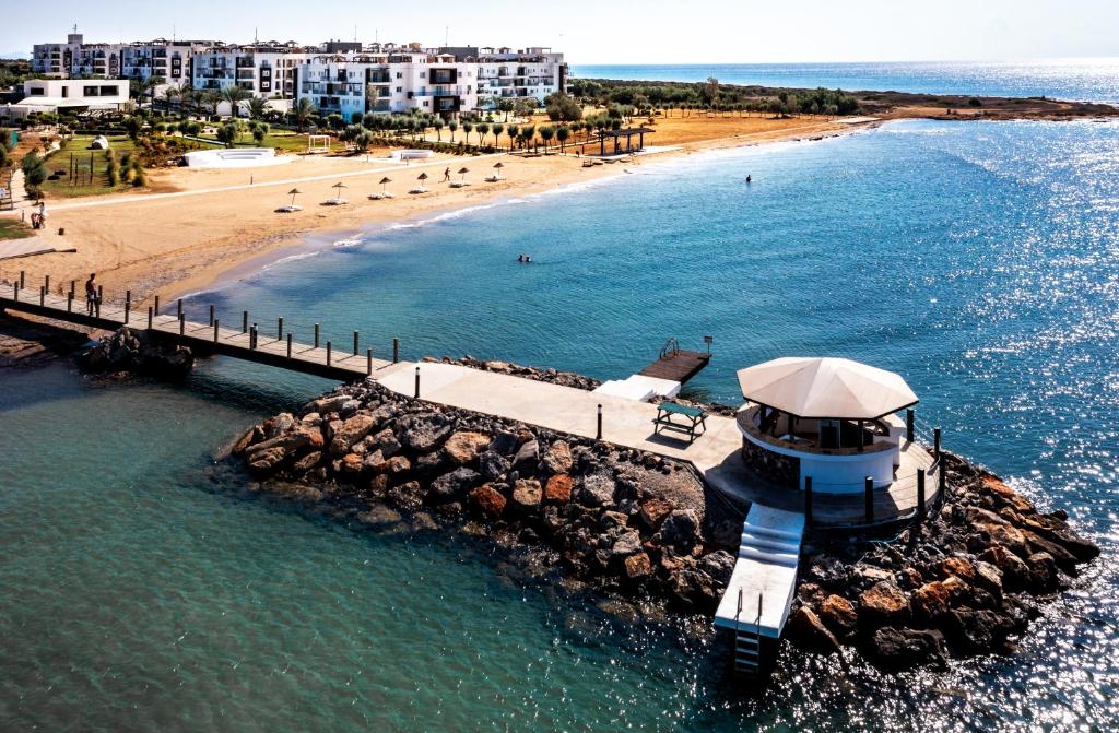 an aerial view of a pier and a beach at Thalassa Beach Resort in Vokolidha