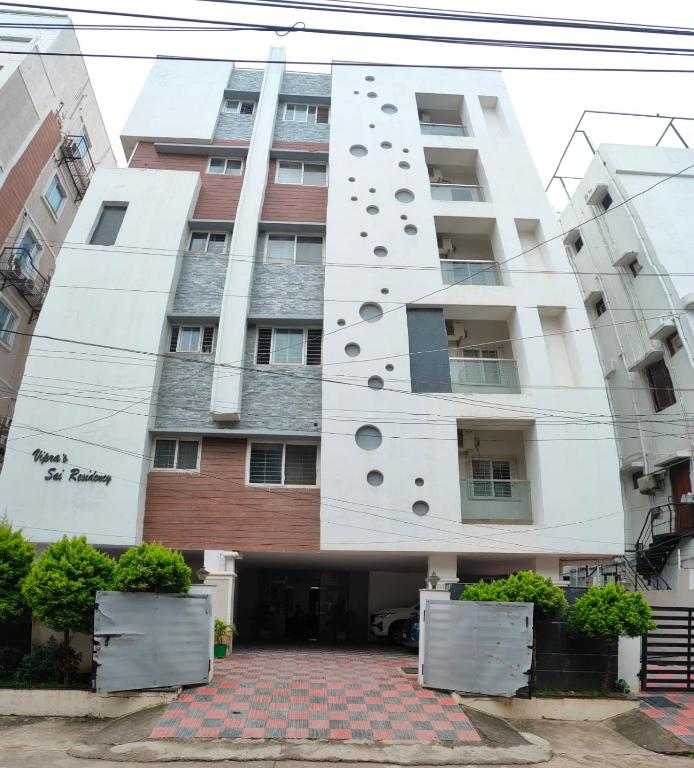 a building with a facade with holes in it at Sapphire Asta Apartments in Hyderabad