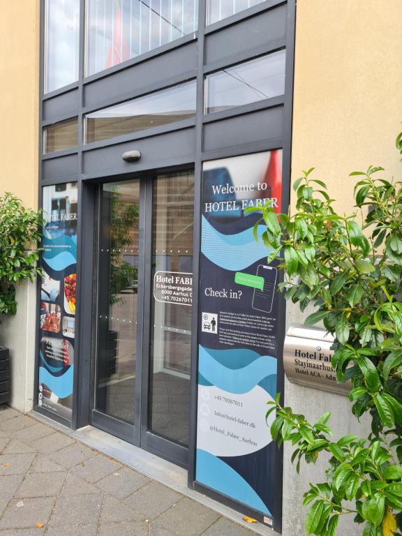a glass door of a building with a sign on it at ApartHotel Faber in Aarhus
